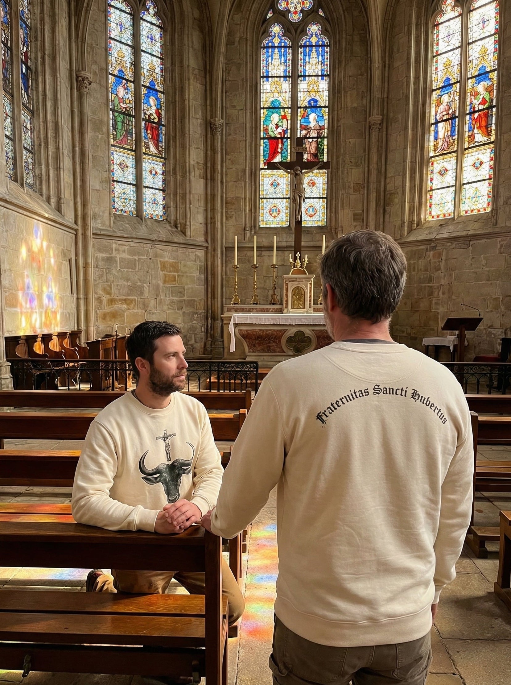 Two Fraternity brothers in a Catholic church with stained glass windows and wooden pews.