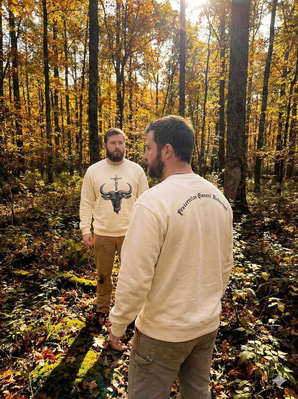 Two FOSH men standing in a forest during autumn, wearing matching Fraternity of St. Hubert  sweatshirts.