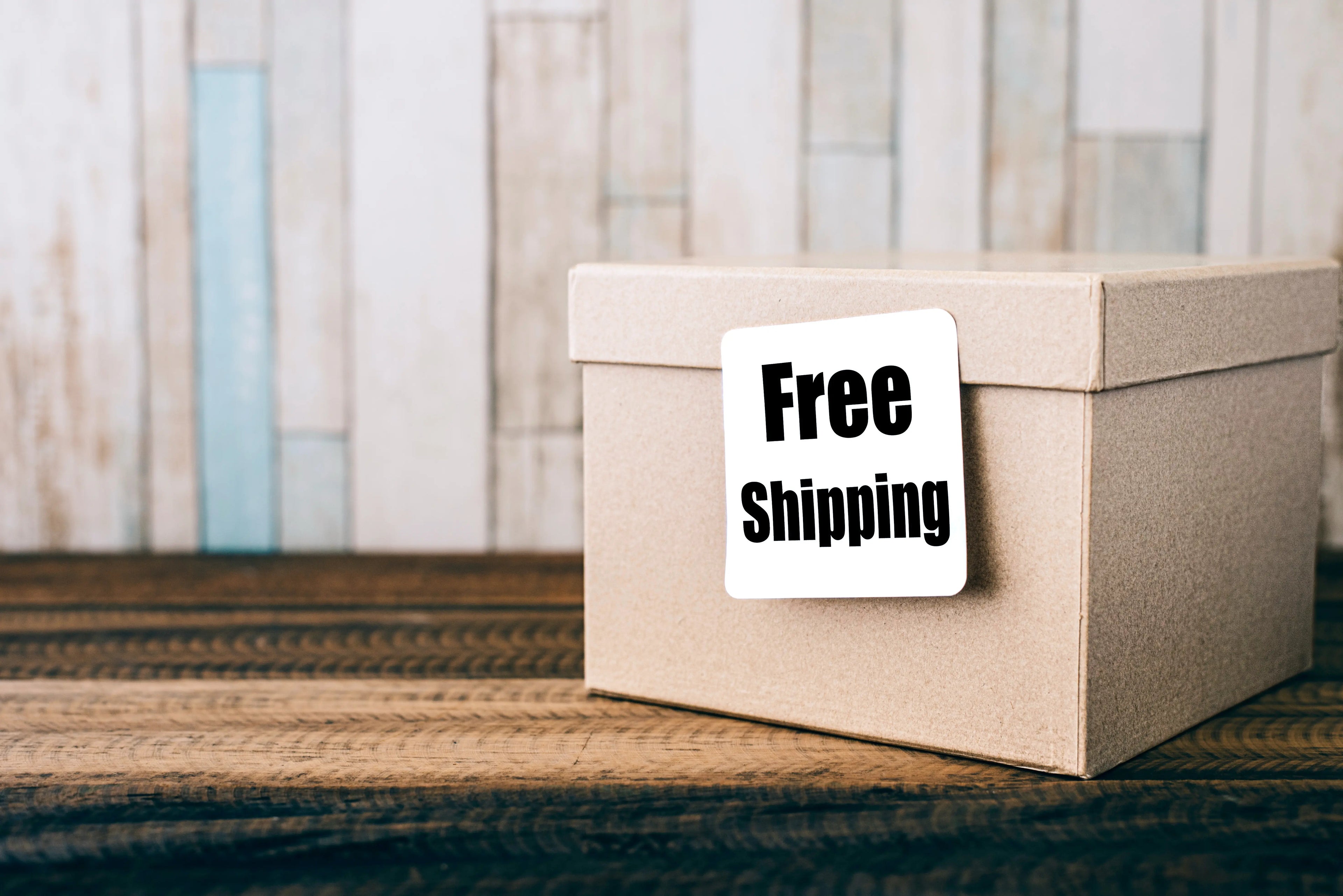 Rustic e-commerce packaging featuring a Free Shipping sticker on a wooden surface.